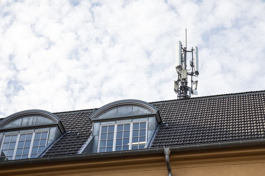 5g antenne auf einem Hausdach Stock Photo